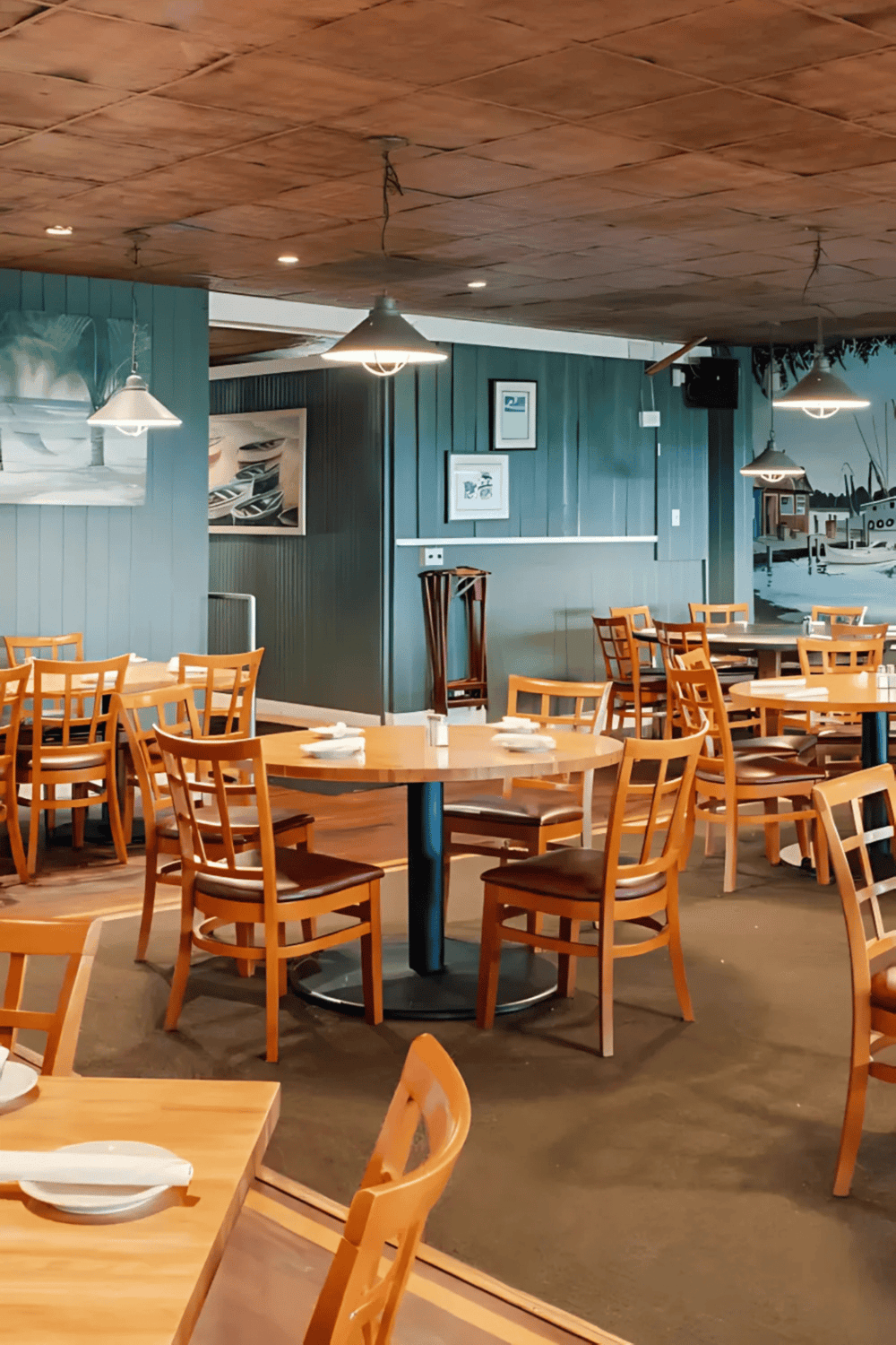 Cozy waterfront restaurant with nautical decor, outdoor seating, and ocean views, ideal for dining and relaxation.