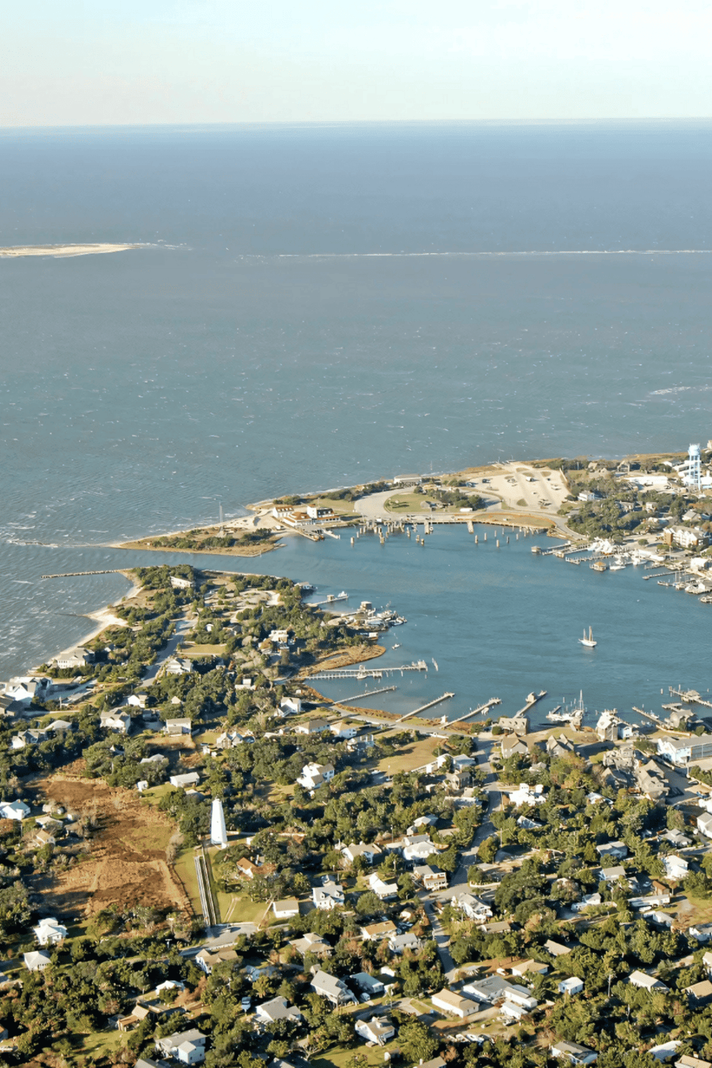 Aerial view of a coastal town with marinas and water channels, showcasing scenic seaside living.
