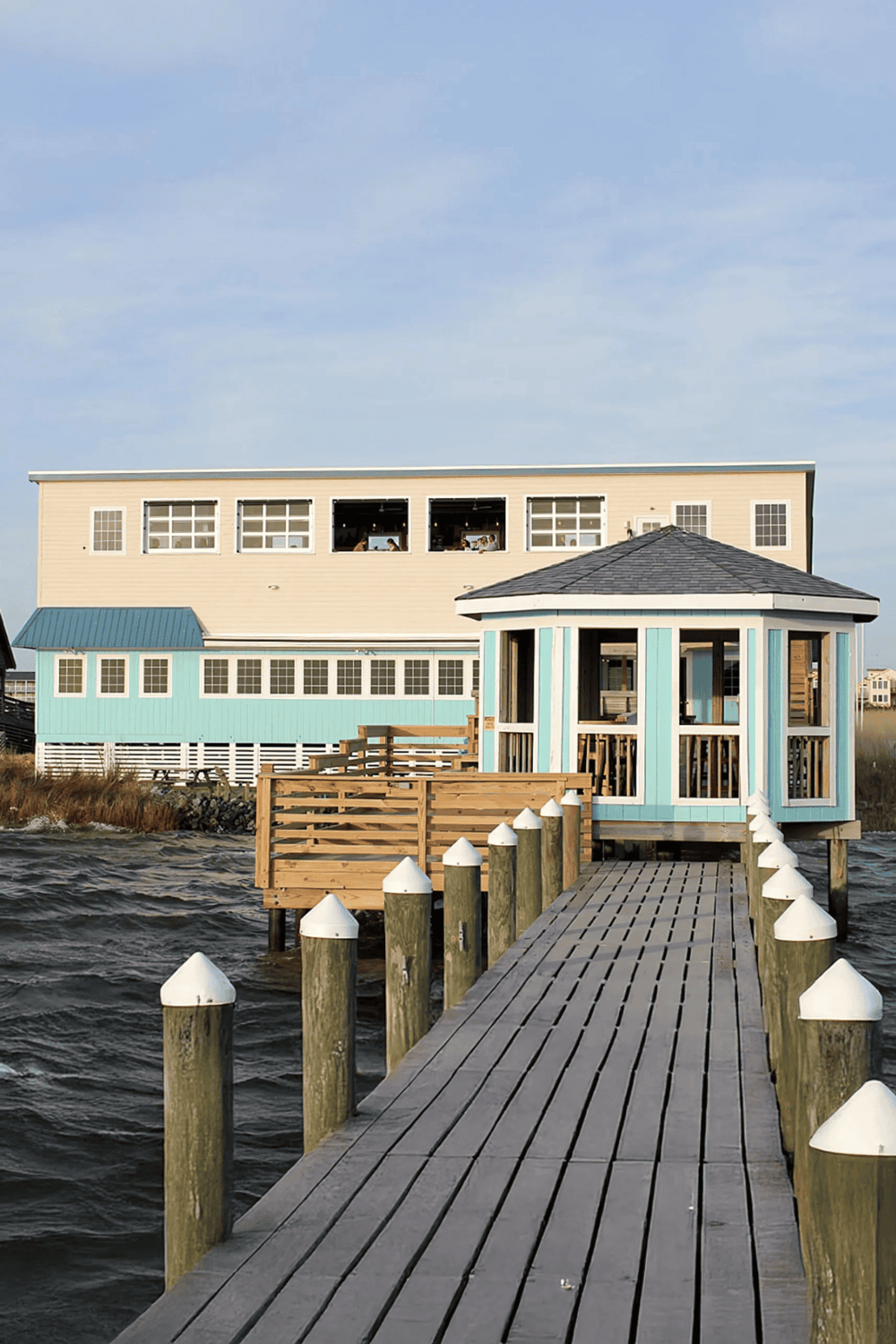 1. Colorful coastal house with pier and water view, seaside vacation home, boat dock, serene waterfront retreat.