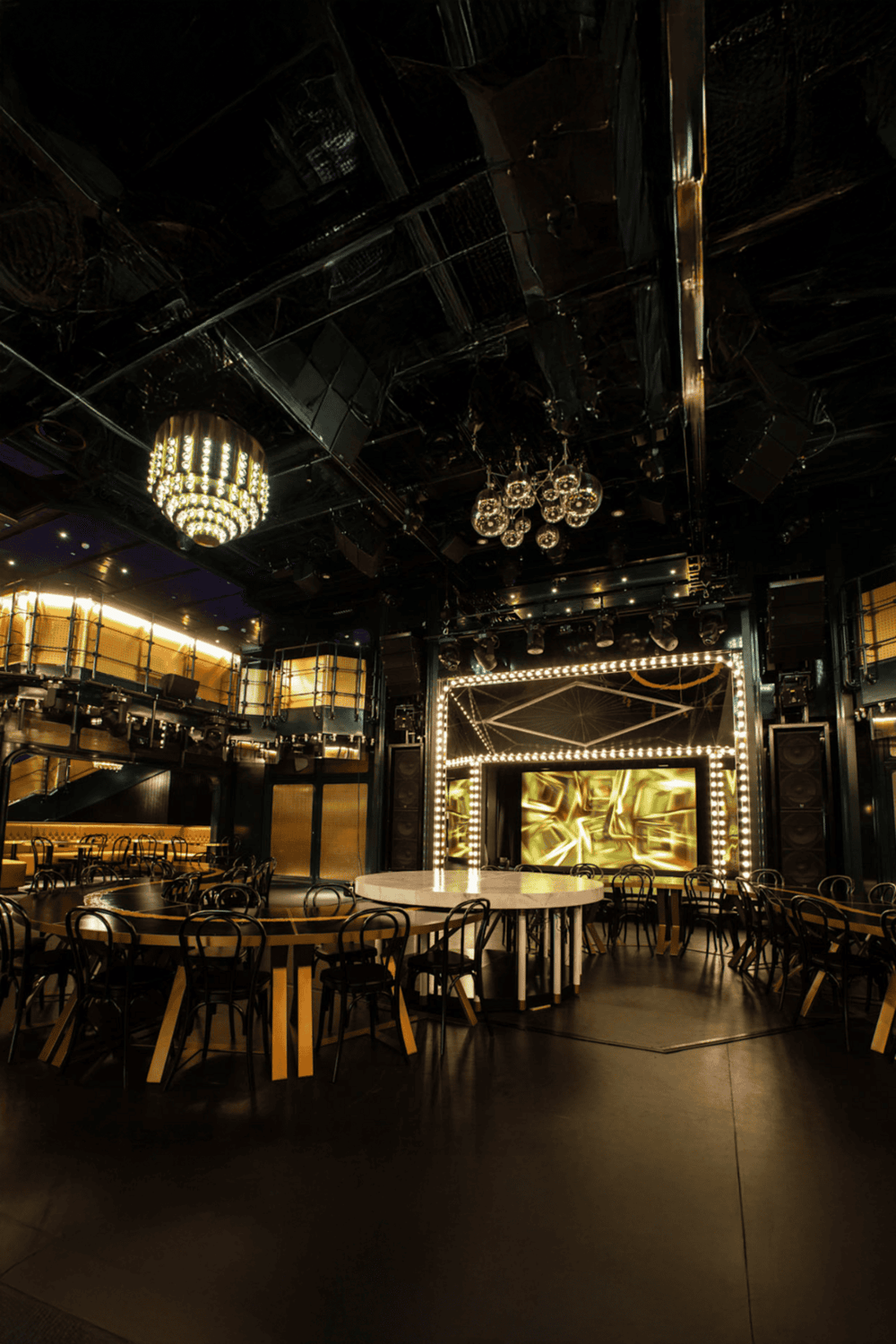 Elegant modern event space with stage and lighting, ideal for parties, performances, and entertainment venues.