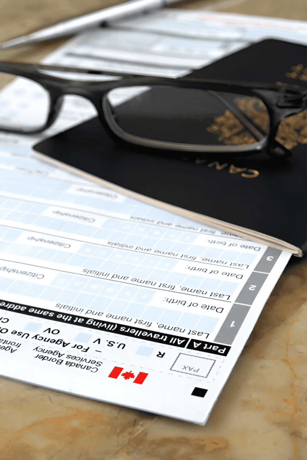Reading Canadian driving and travel documents with glasses on a table.