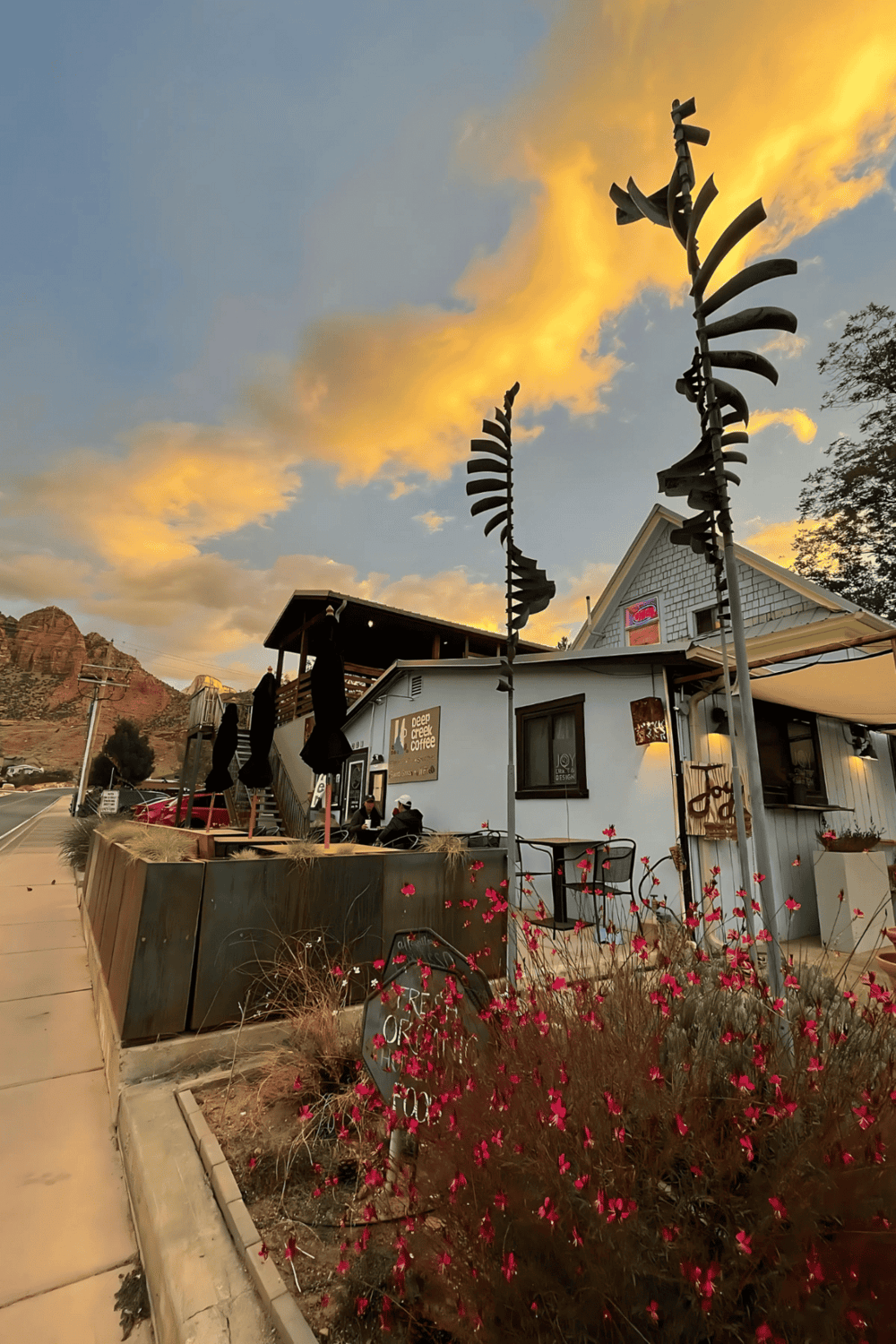 Cozy coffee shop with unique sculpture art and mountain view at sunset.