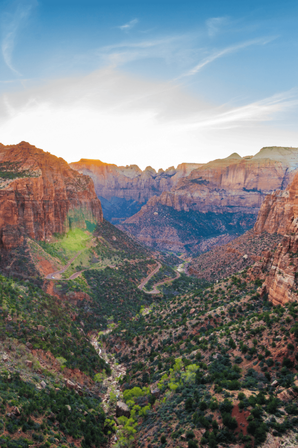 Vast Grand Canyon landscape with winding roads and colorful rock formations, perfect for adventure travel.