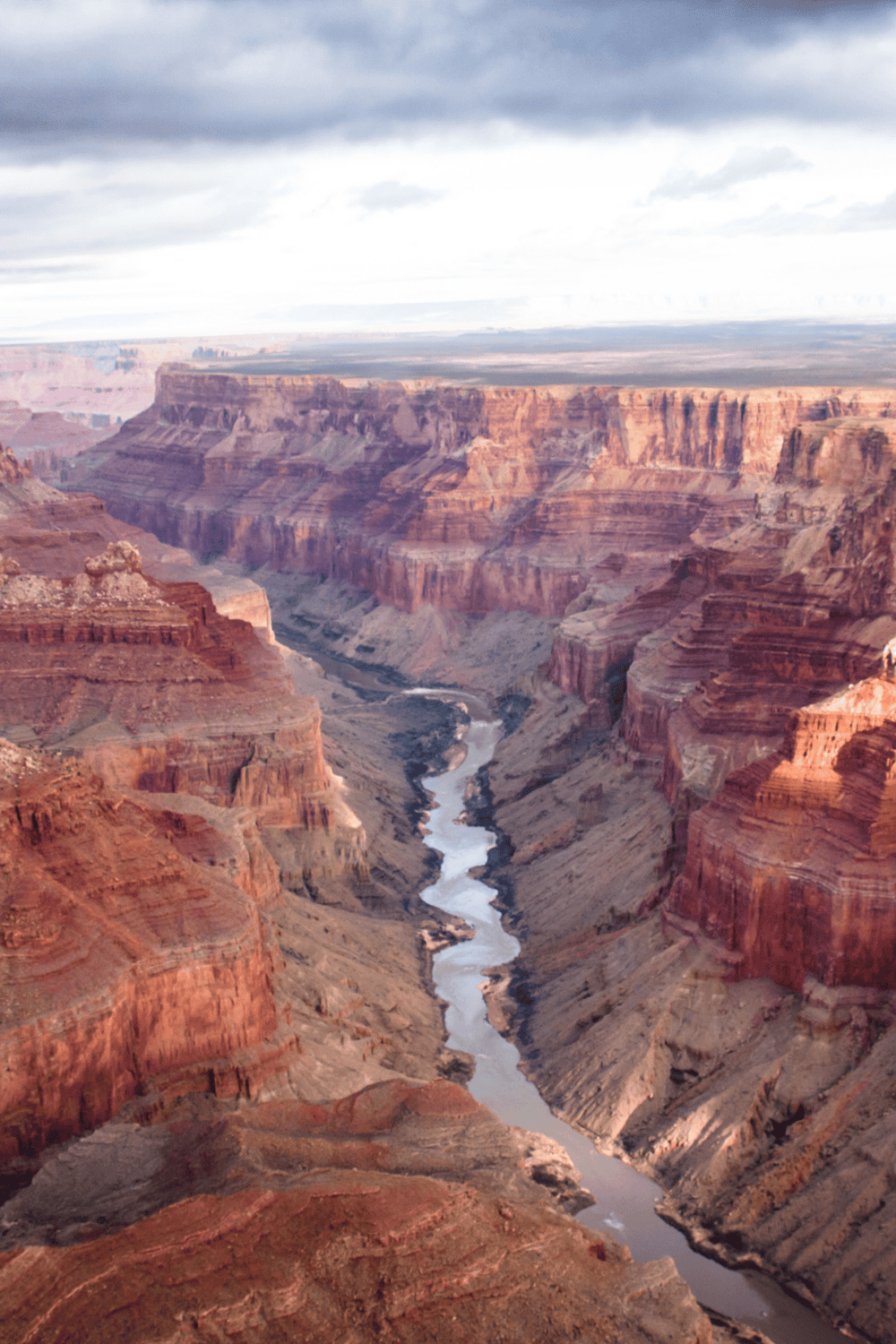 Vibrant Grand Canyon landscape, red rock formations, and Colorado River, popular outdoor travel destination.