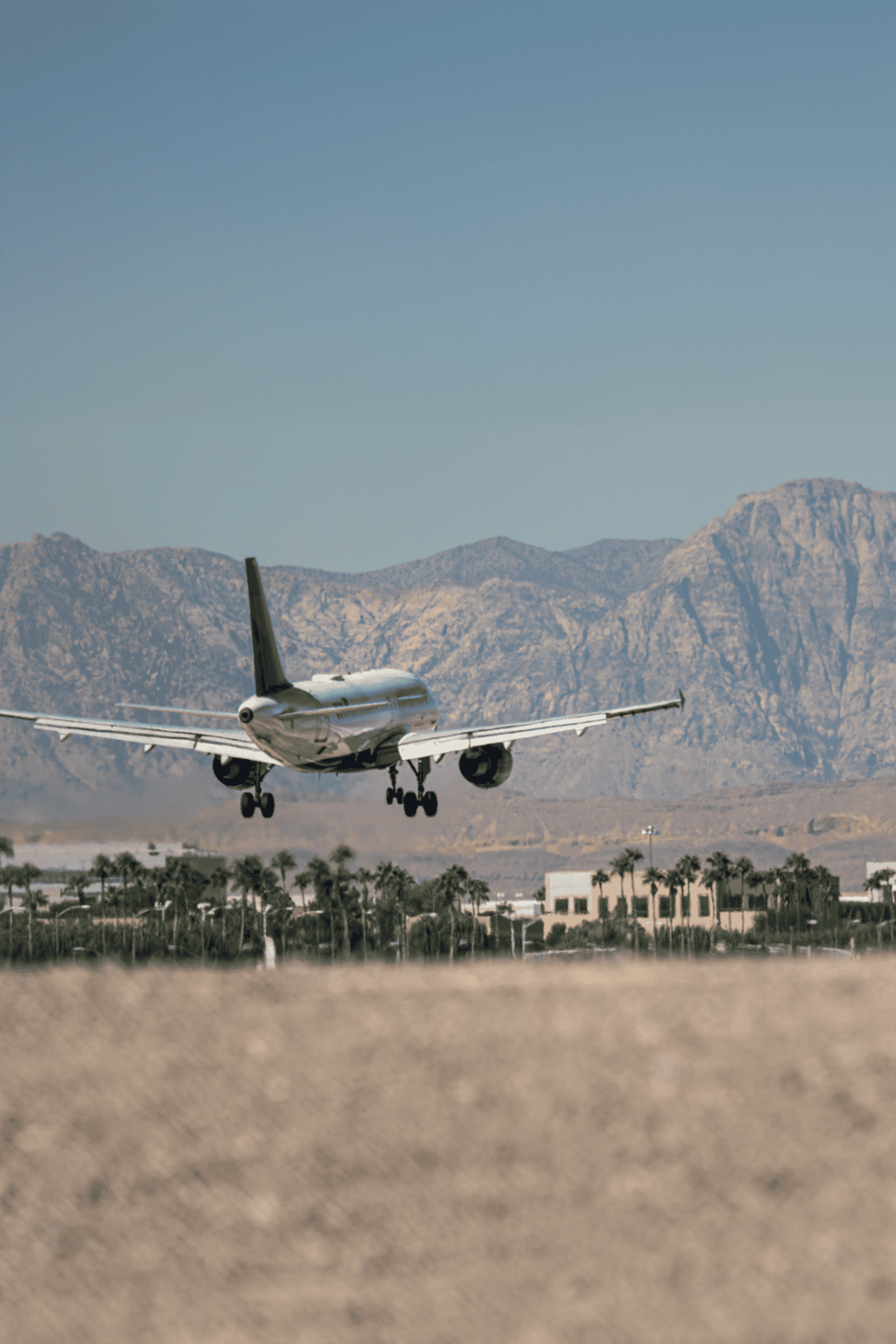 Private jet taking off with mountain backdrop and desert landscape, luxury travel, aviation, corporate jet, flight.