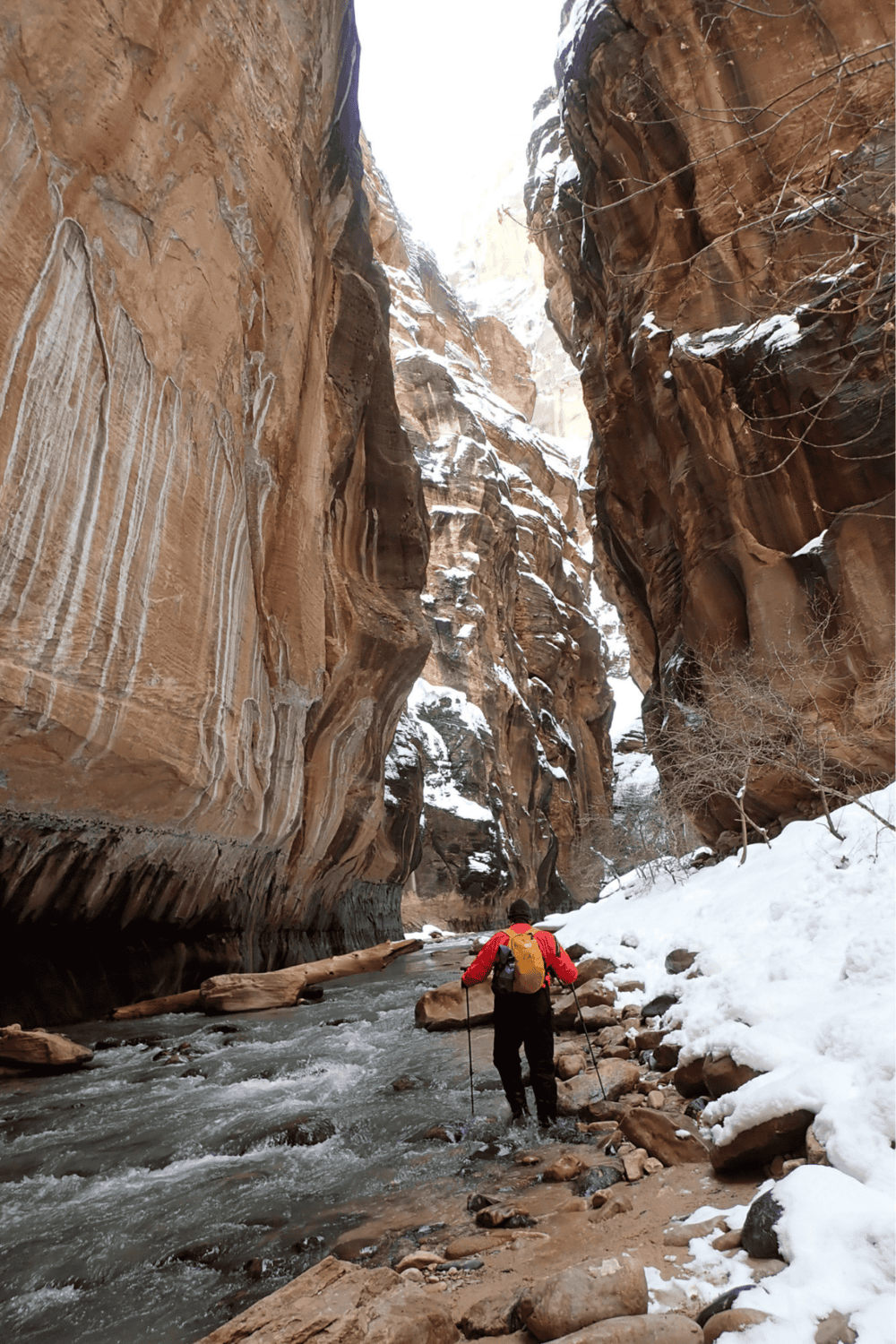 1. Narrow canyon with icy river and snow-covered rocks, adventure hiking in rugged canyon terrain.