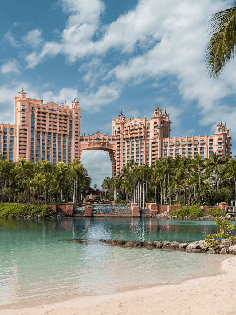Luxury resort with pink castle-like architecture near beach in Bahamas.