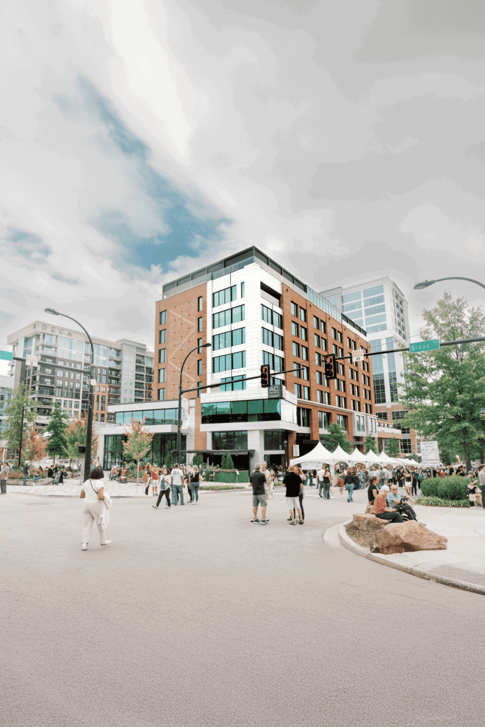 Modern urban building with people at a city intersection, best for travel and navigation keywords.