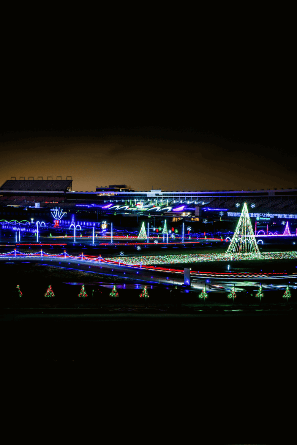 Bright Christmas light display with festive decorations and colorful illuminations at night.