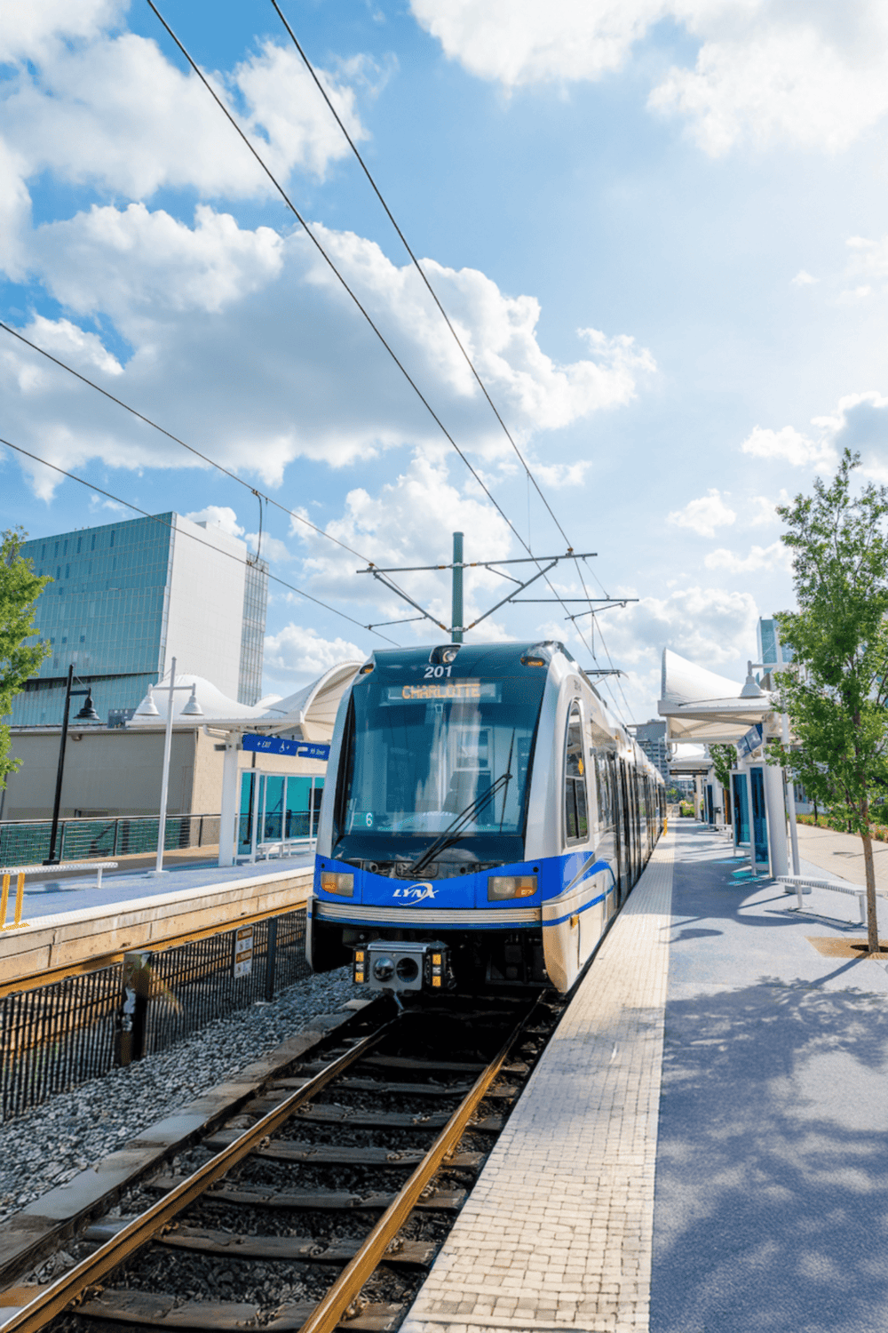 Modern light rail train at a city transit station, promoting efficient urban transportation.