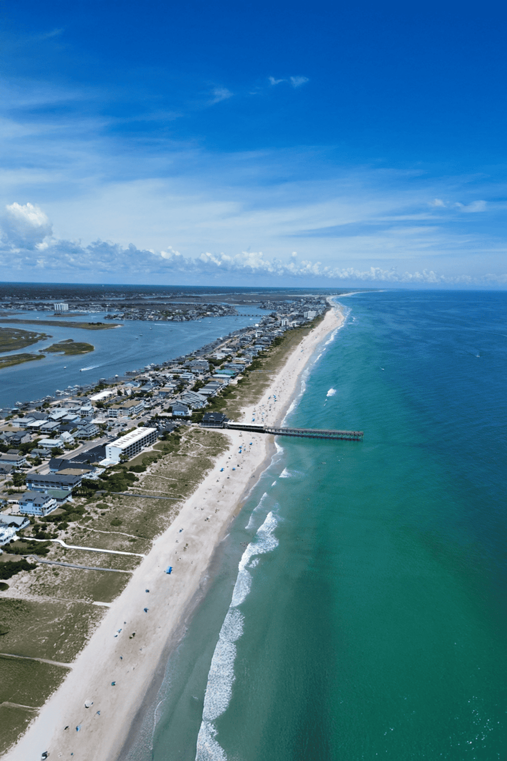 Aerial view of scenic Florida coast with beach, ocean, and coastal houses, perfect for travel planning.