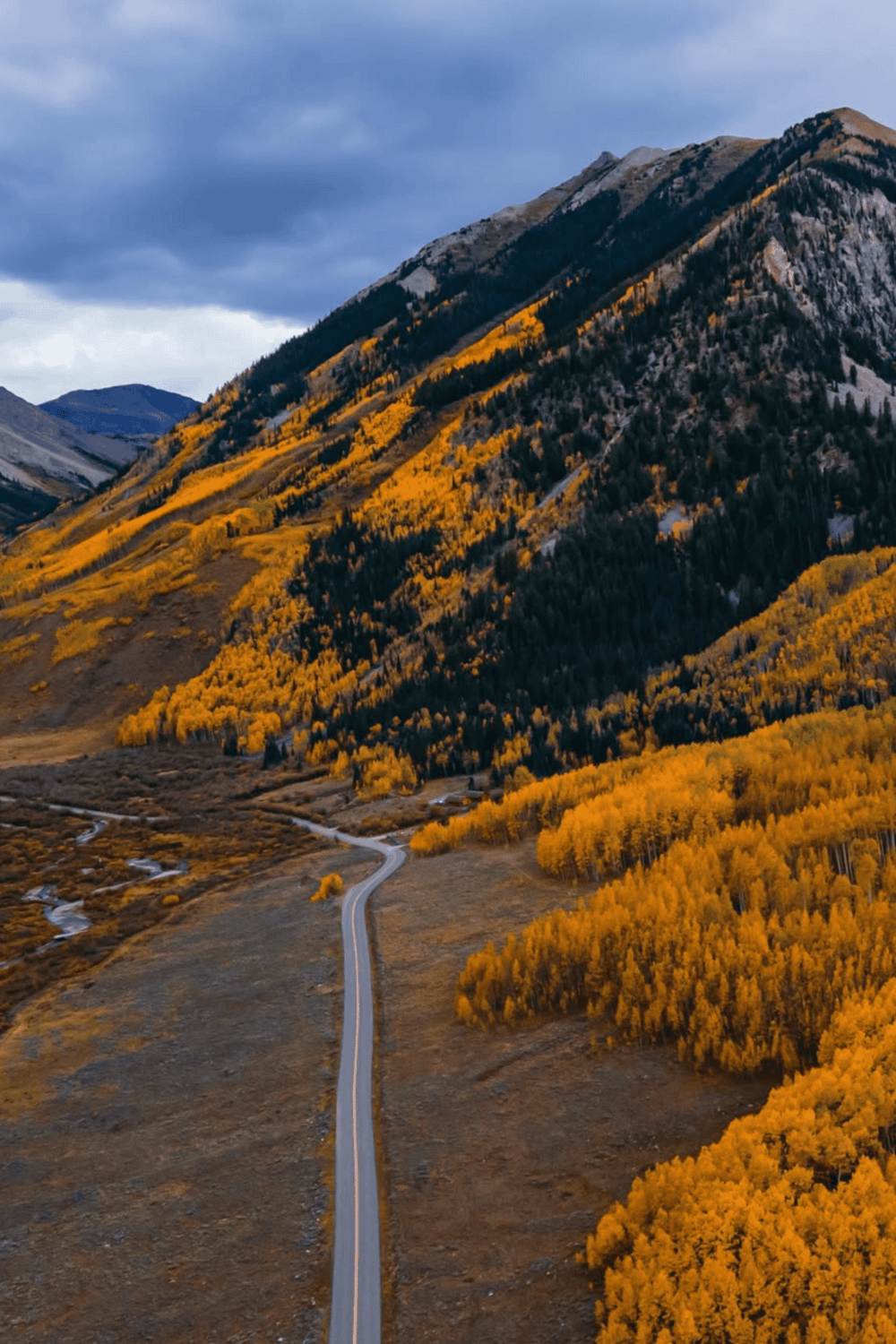 Scenic mountain road surrounded by autumn foliage at QuestForDirections.