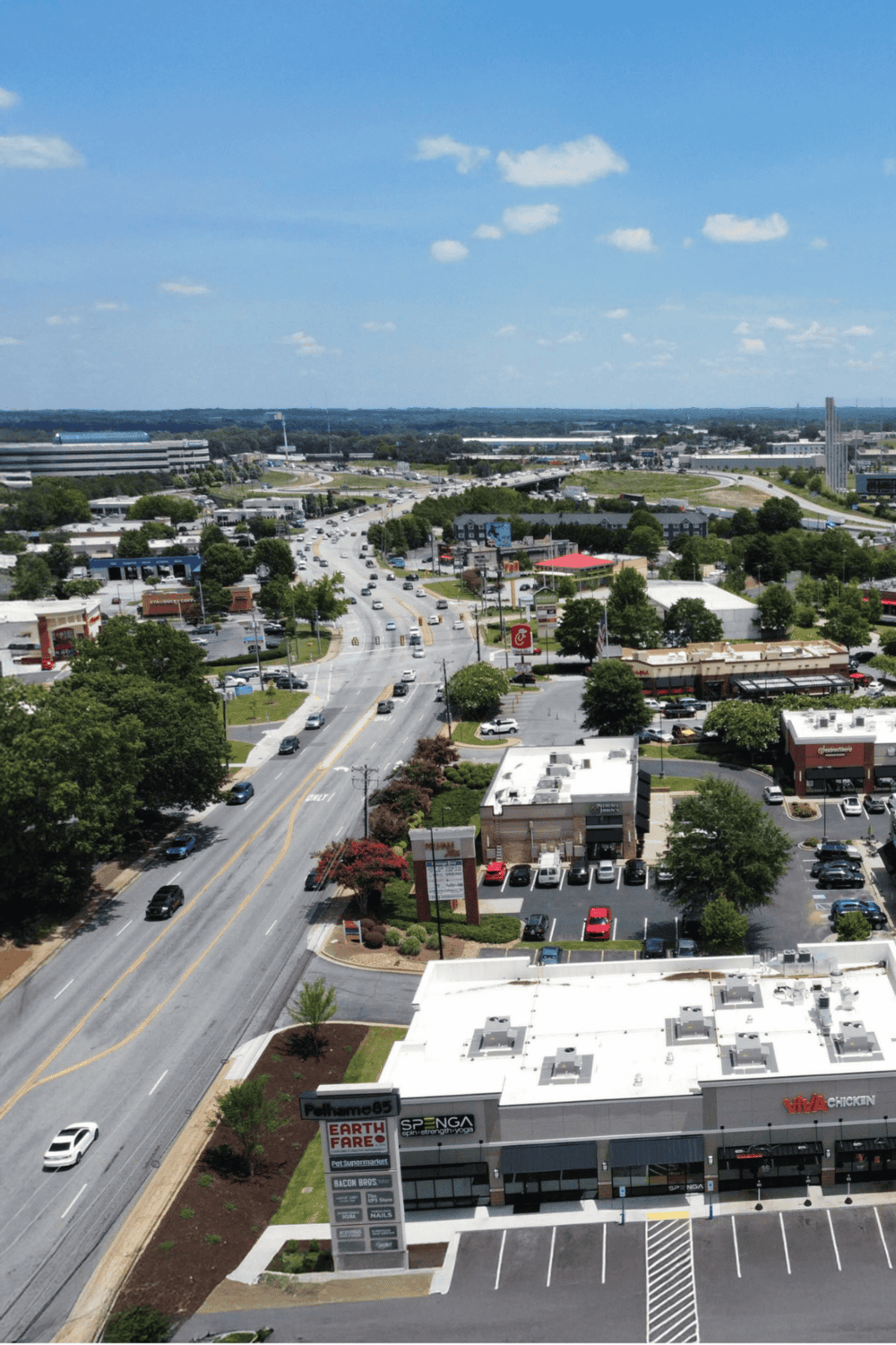 1. Aerial view of shopping plaza and busy street in questfor directions area.