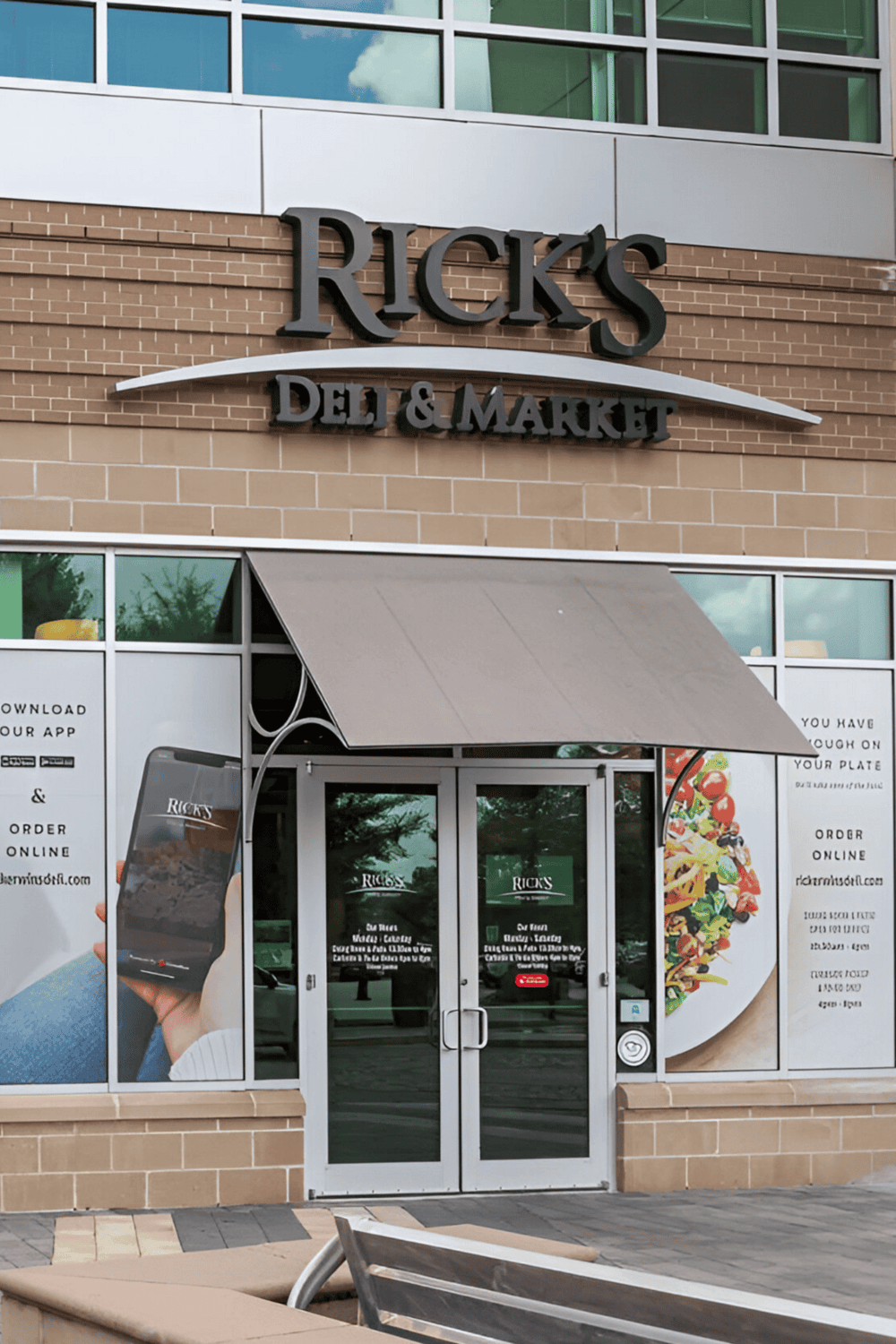 1. Grocery store front with Ricks deli and market signage in upscale shopping center.
