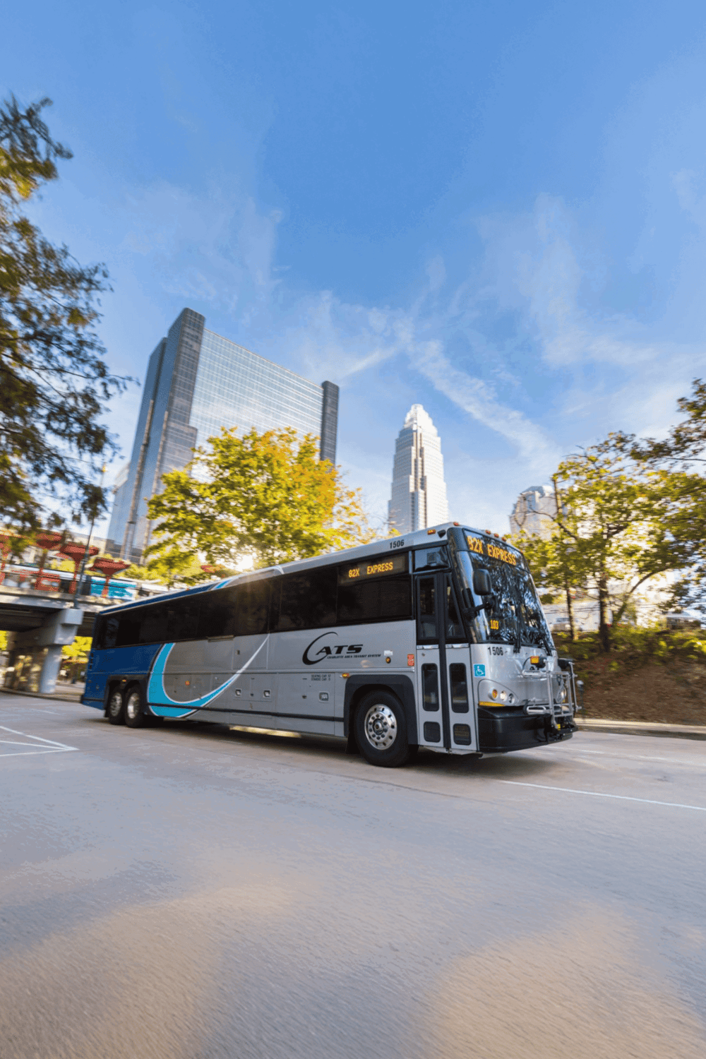 Public transportation bus in downtown city with skyscrapers, part of QuestForDirections transit services.