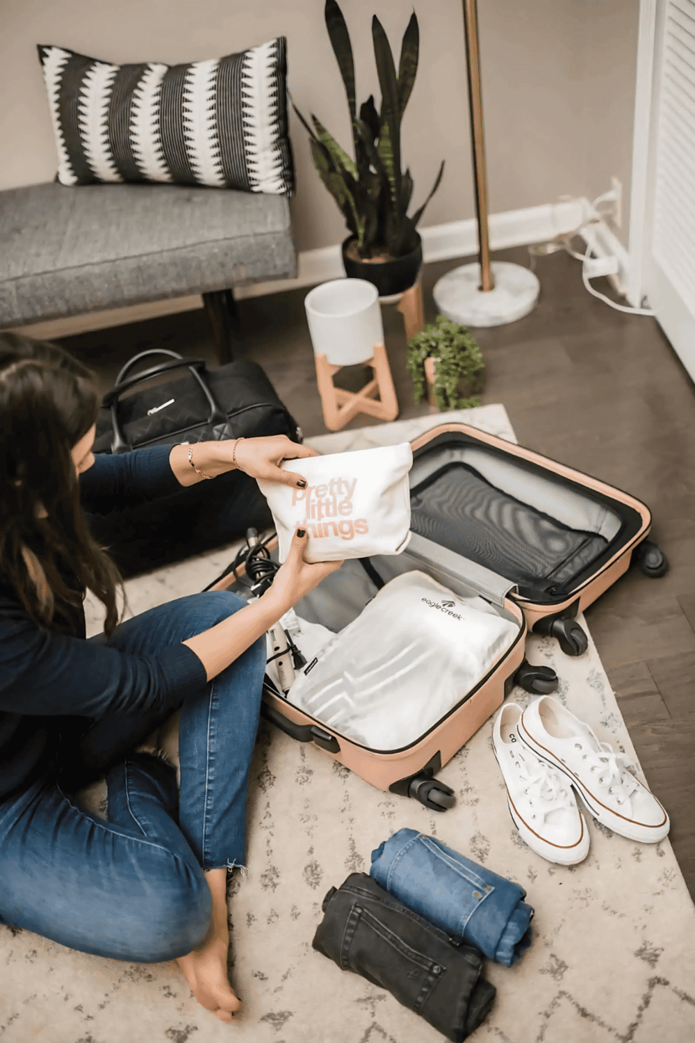 1. Woman packing suitcase with travel essentials for vacation or trip travel.