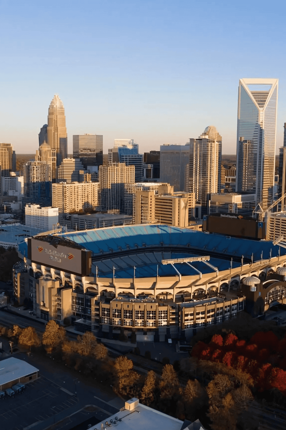 Downtown Charlotte skyline with Bank of America Stadium, modern skyscrapers, vibrant cityscape, North Carolina business hub, QuestForDirections.