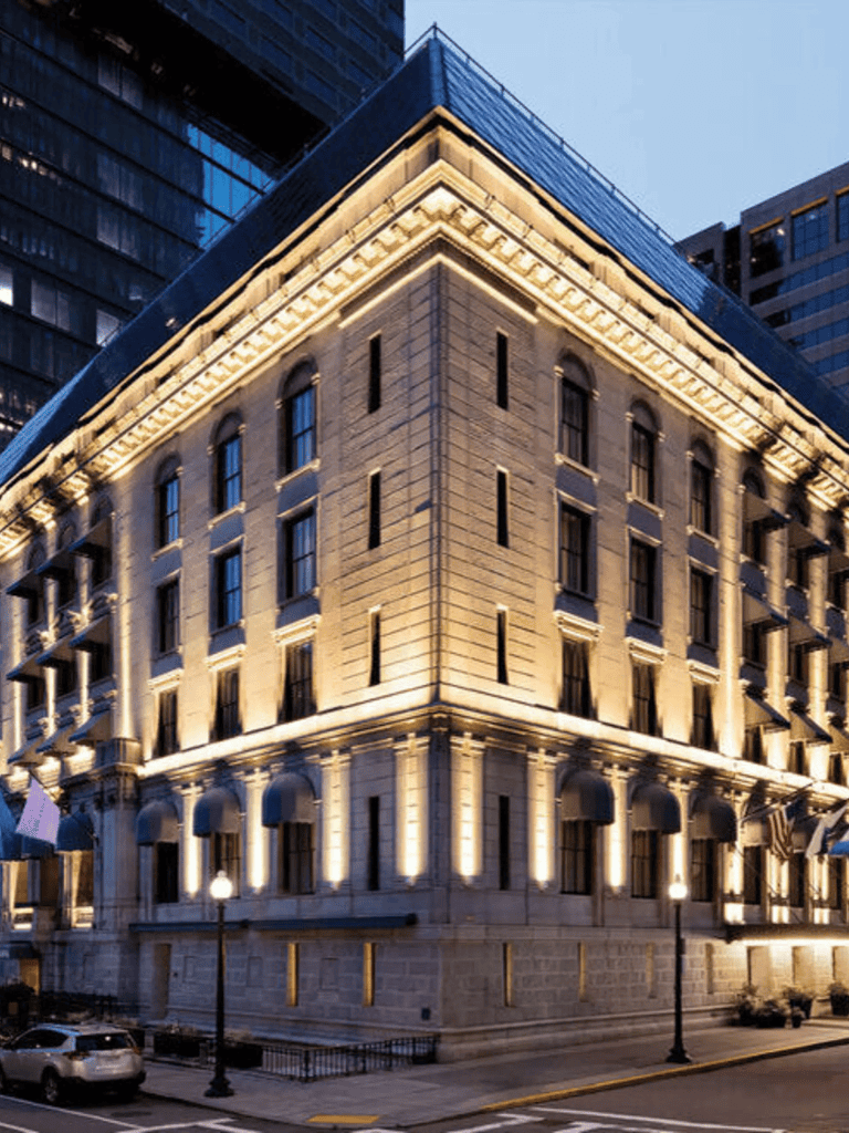 Elegant historic building illuminated at night in downtown cityscape.