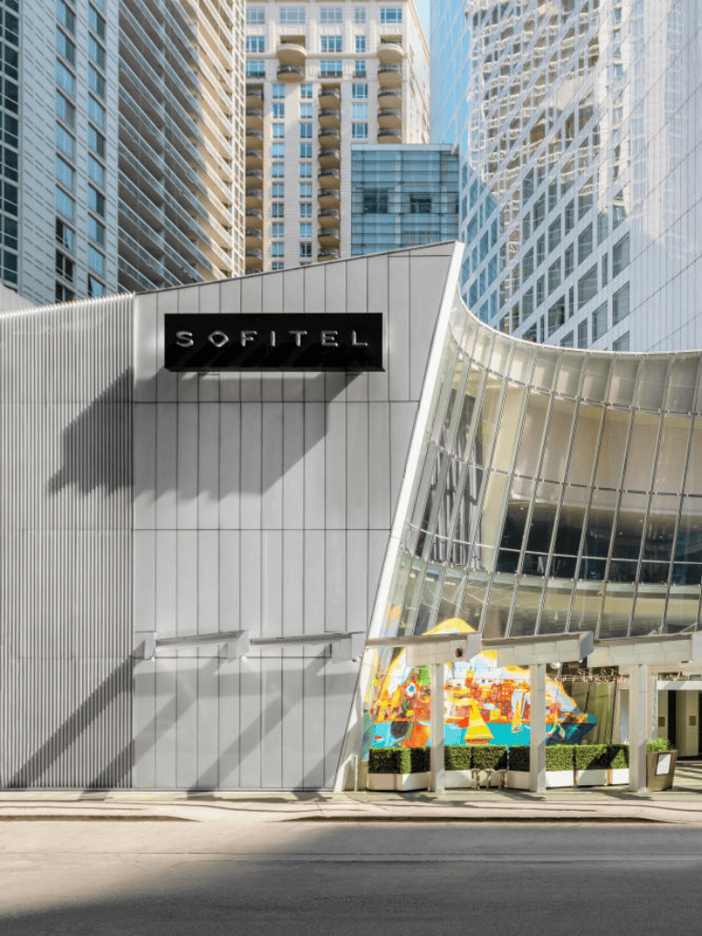 Sofitel hotel in downtown modern cityscape with high-rise buildings and stylish architecture.