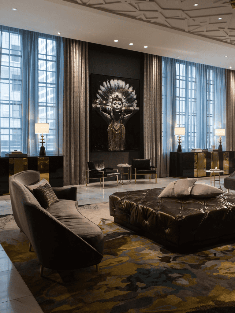 Luxurious hotel lobby with modern decor, art piece, and comfortable seating area.