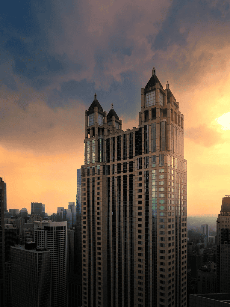 Stunning view of a skyscraper at sunset in a vibrant city skyline.