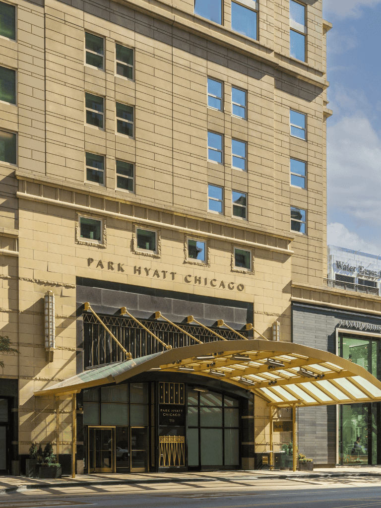 Modern hotel exterior at Park Hyatt Chicago with stylish entrance and cityscape background.