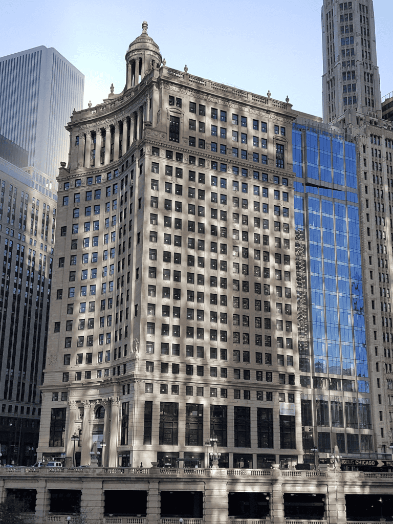 Grand Chicago skyscraper with historic architecture and modern glass facade in downtown area.