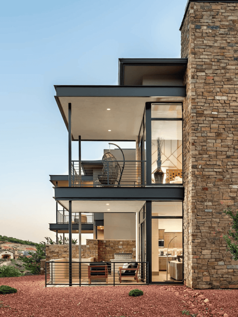 Modern luxury home with expansive balconies and stone accents, stunning architecture design.