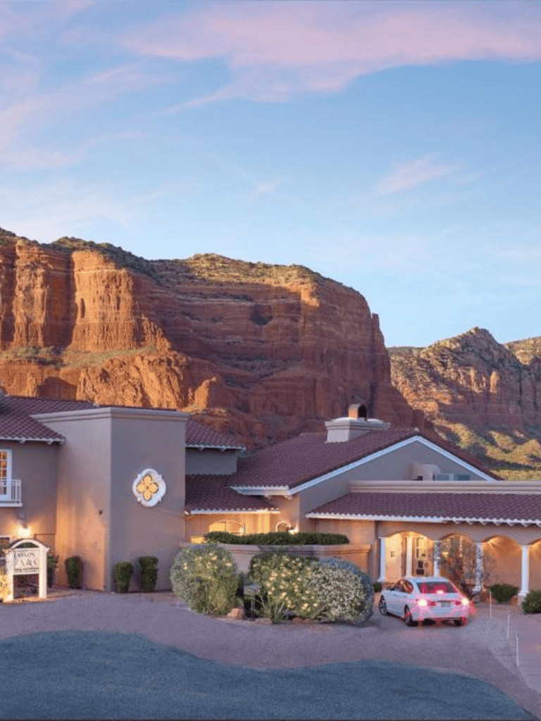 QuestForDirections scenic mountain and residential neighborhood with red rock formations.