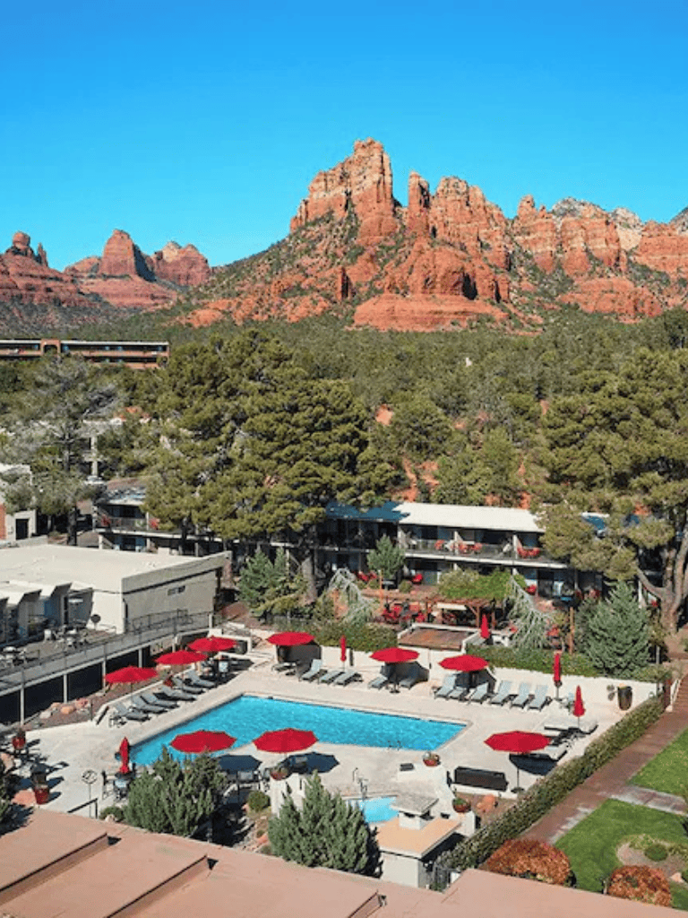 Red rock mountains at Sedona, Arizona with pool and resort area in foreground.