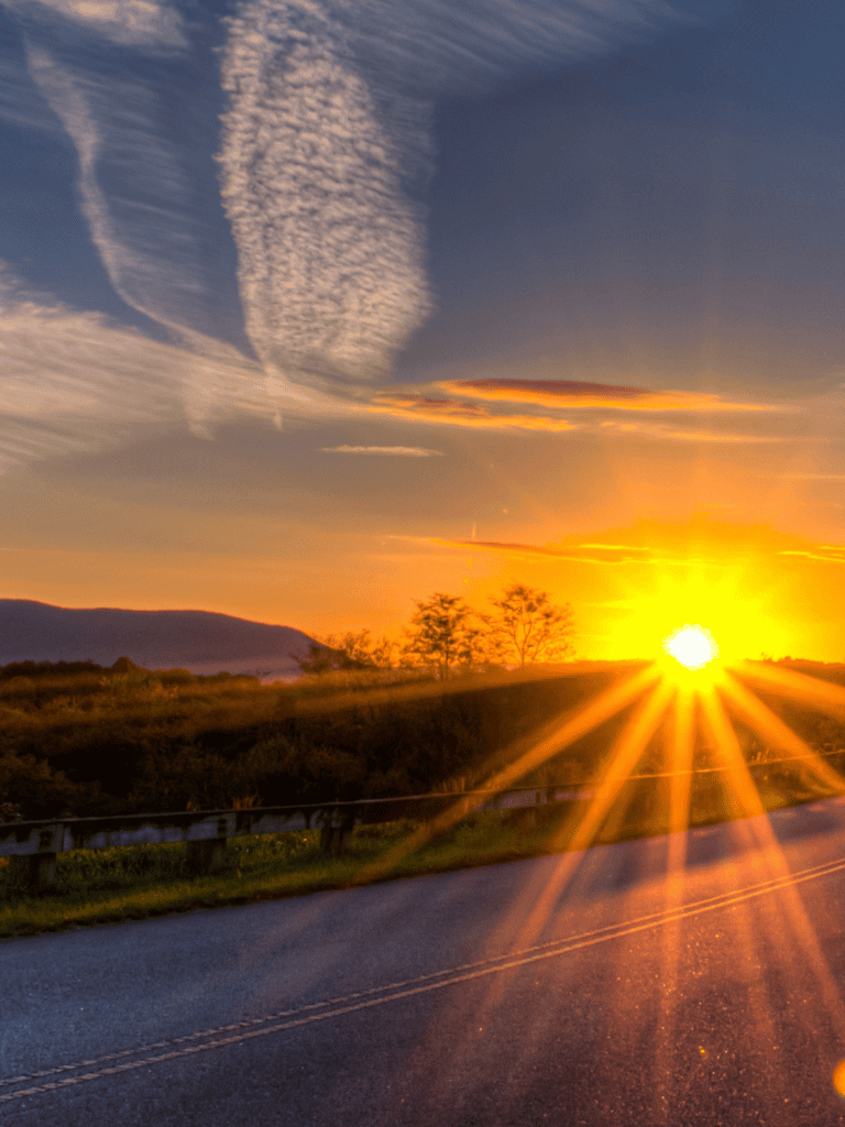Stunning sunset over open road, scenic landscape, nature travel, quest for direction, road trip inspiration.