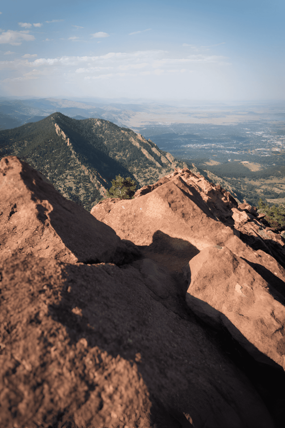 Breathtaking mountain view with rugged rocks and expansive valley, perfect for adventure and navigation.