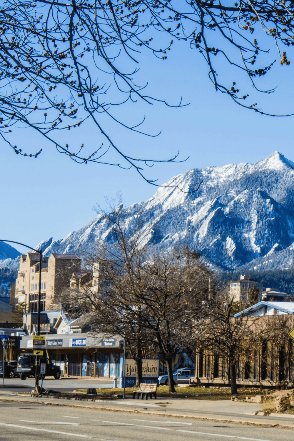 Golden, snow-capped mountain skyline with town and downtown shops, perfect for travel and exploration guides.