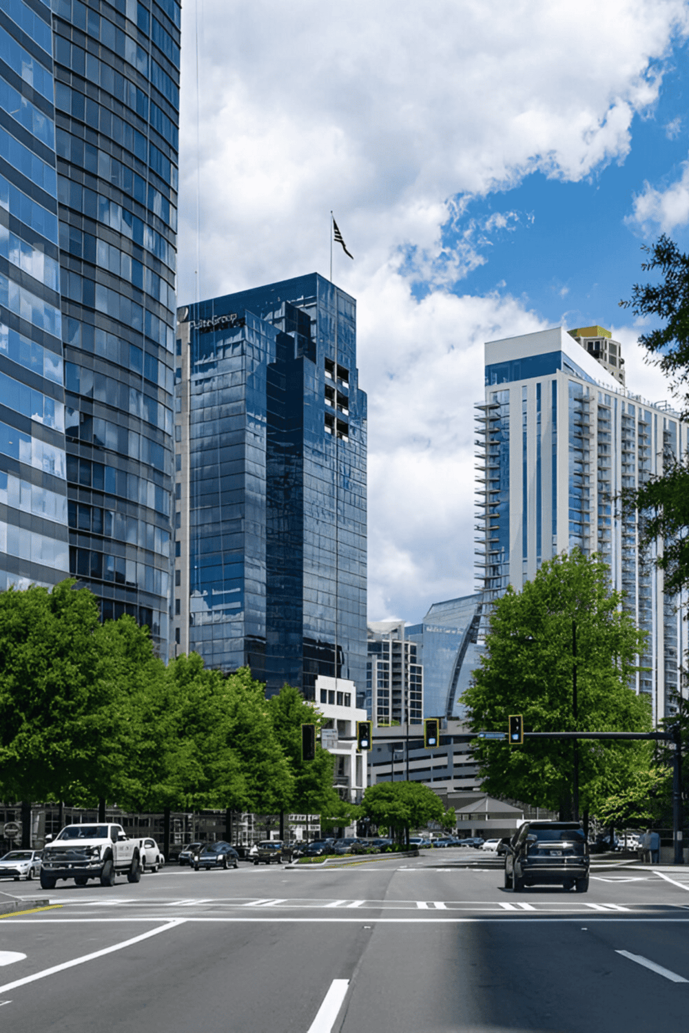 Modern downtown skyscrapers with glass facades and city traffic.