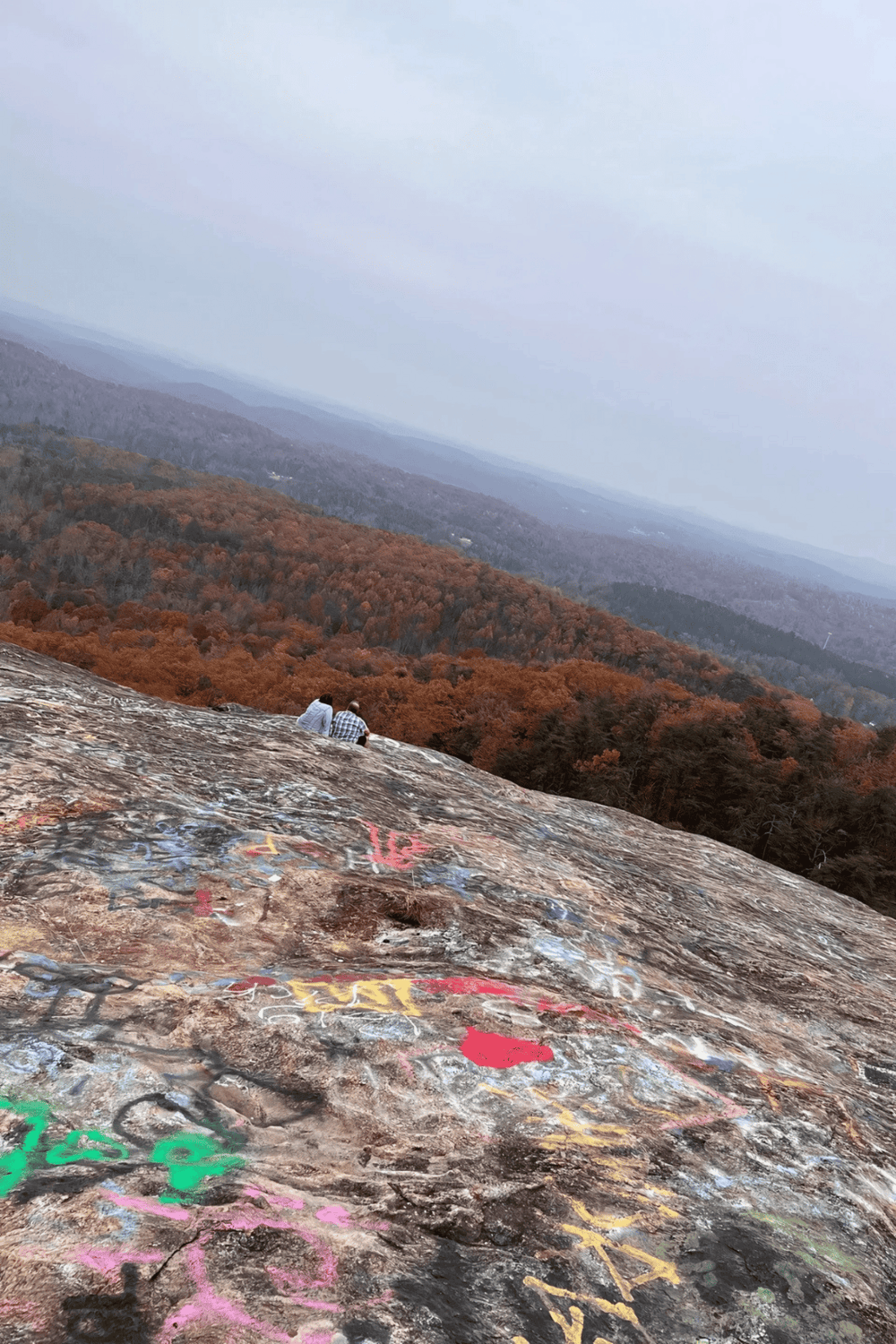 1. Overlook viewpoint in the mountains with graffiti-covered rocks and colorful fall foliage.