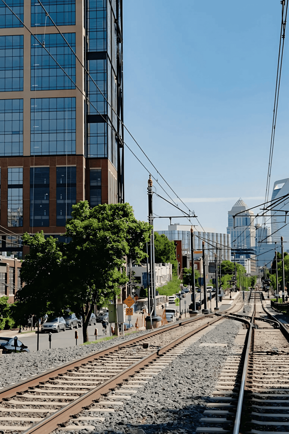 Modern cityscape with skyscrapers and railway tracks, urban transportation, and downtown architecture.