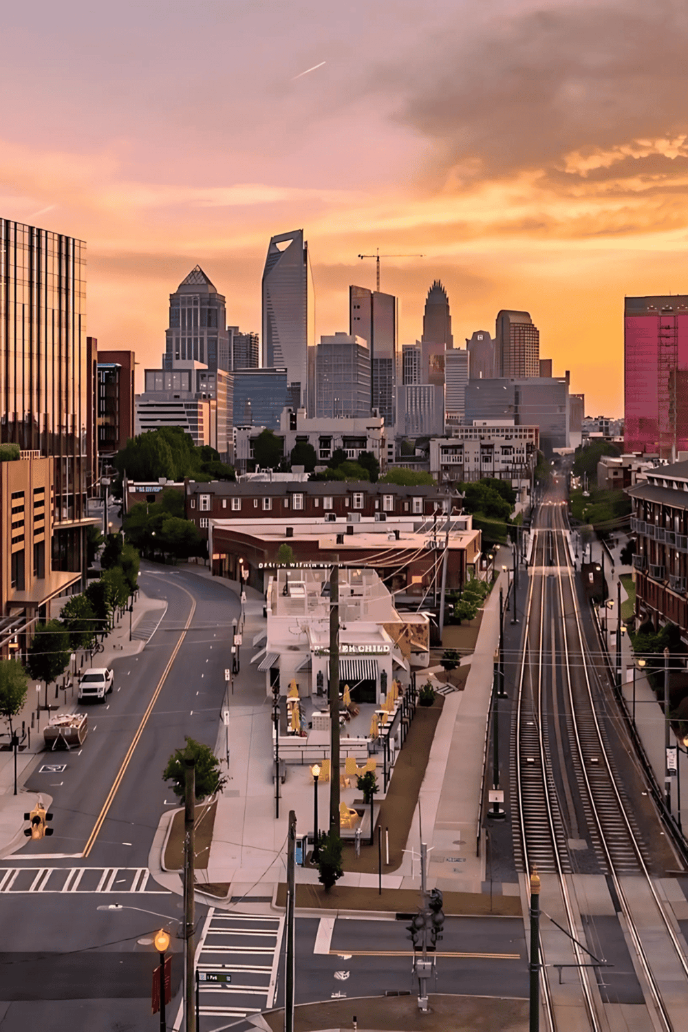 Colorful city skyline at sunset with skyscrapers and downtown streets in Charlotte, North Carolina.