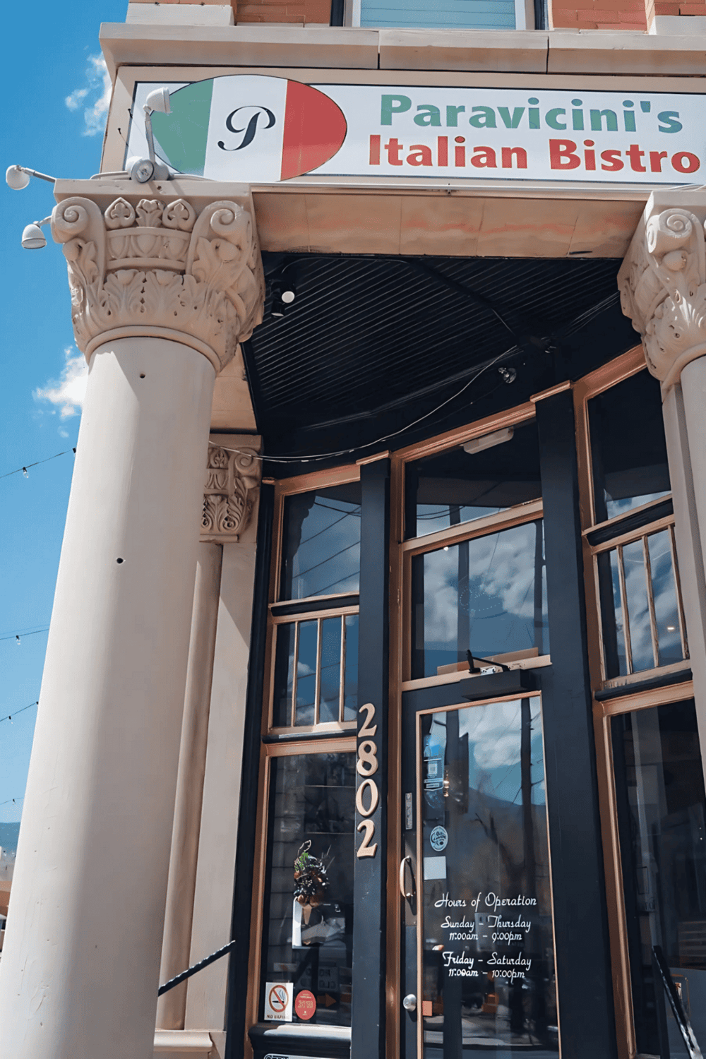 Elegant Italian Bistro exterior with classical columns and inviting glass entrance.