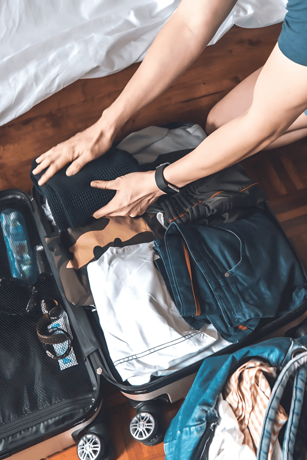 Packing for travel with collected clothing and belongings in a suitcase for a trip.