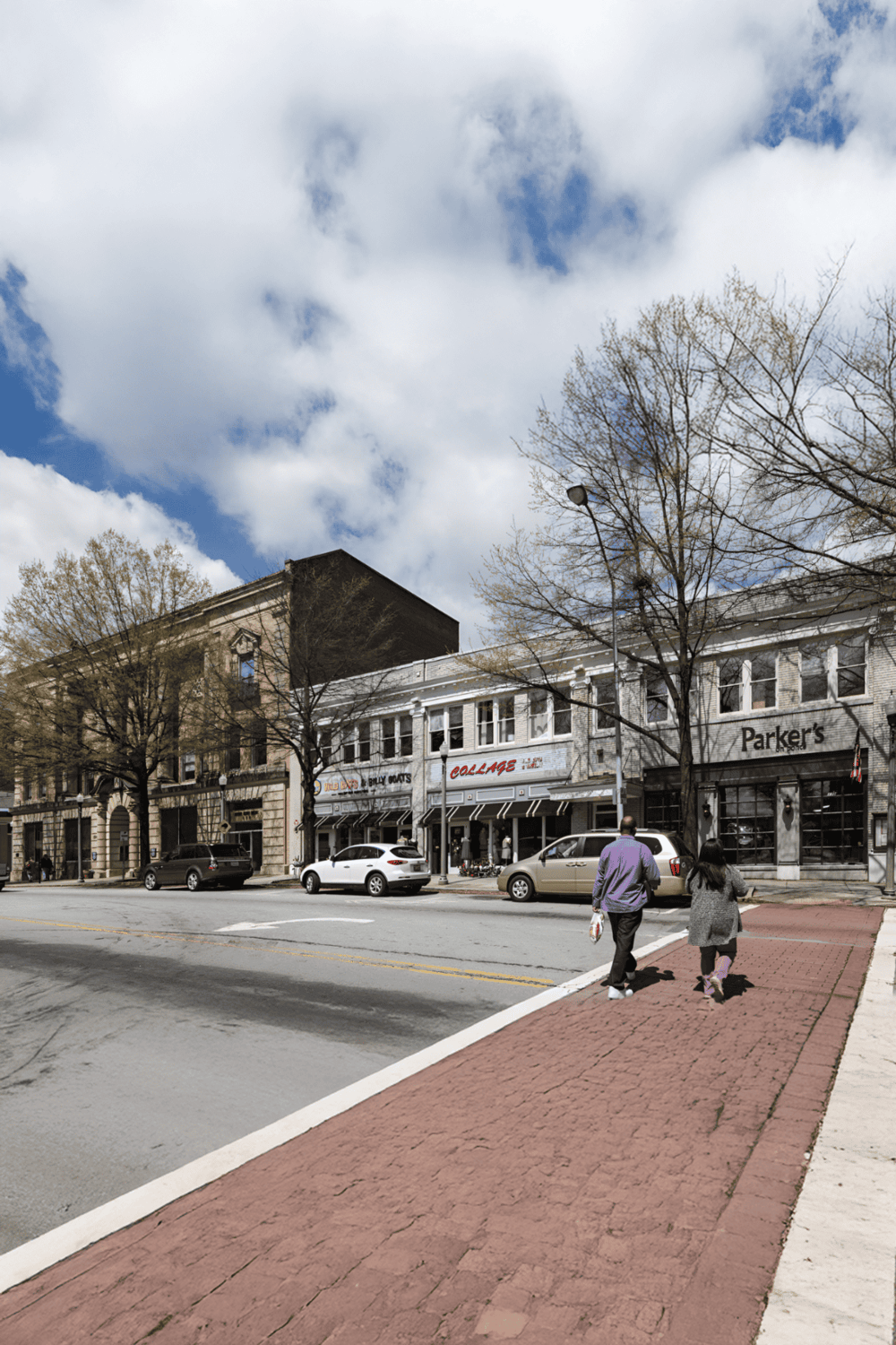 Charming downtown street with shops, pedestrians, and classic architecture in spring season.