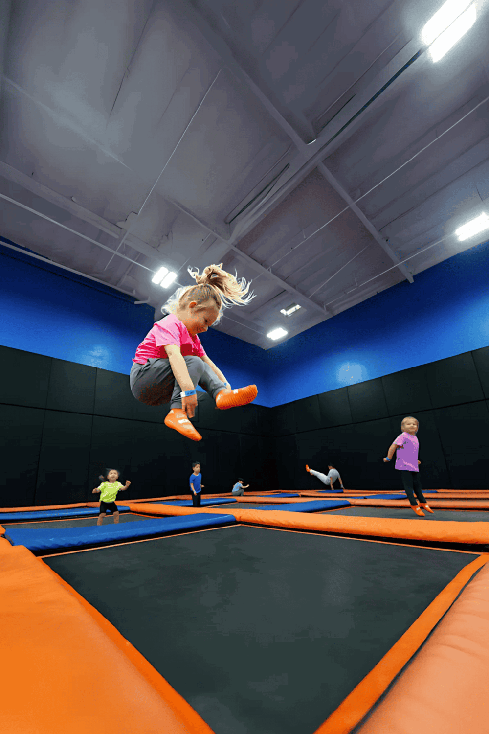 Kids jumping on trampoline at indoor adventure park for kids and family fun with QuestForDirections.