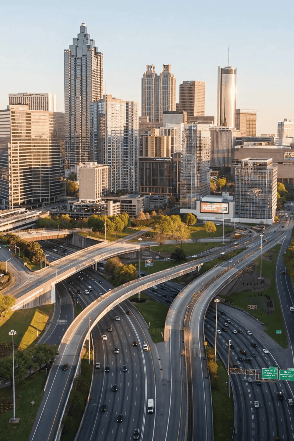 Downtown Los Angeles skyline with highways and modern skyscrapers, urban cityscape at sunset for QuestForDirections SEO.