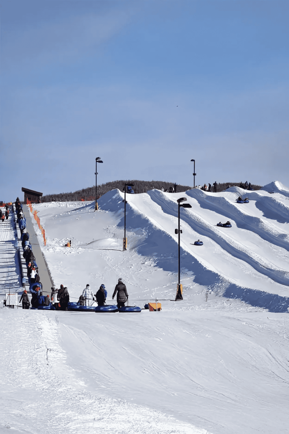 Snow tubing park at QuestForDirections ski resort, family-friendly winter snow activity, snowy slopes, outdoor fun, winter sports.