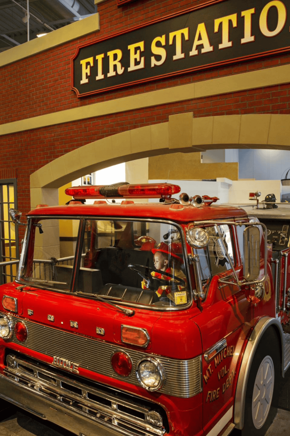 Vintage fire truck display at Fire Station exhibit.