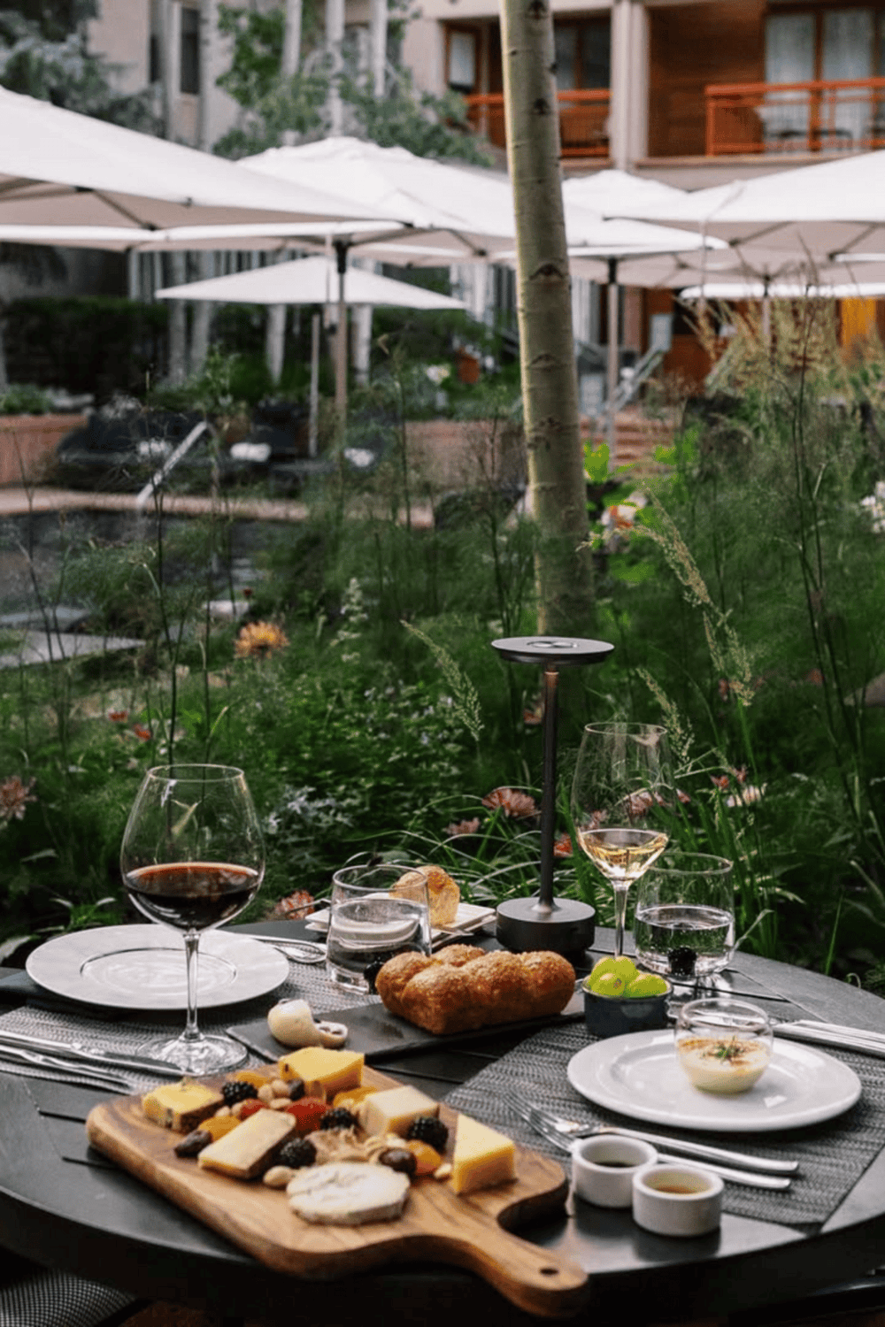 Luxurious outdoor dining scene with wine and cheese, perfect for a romantic dinner at QuestForDirections.