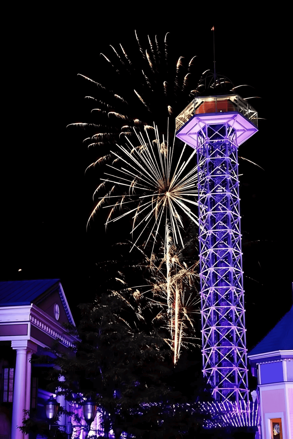 Colorful fireworks illuminate the night sky near the QuestForDirections landmark.