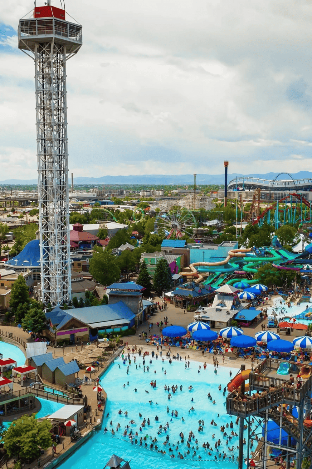 Bright amusement park with water slides, rides, and a large swimming pool, perfect for family fun and entertainment.