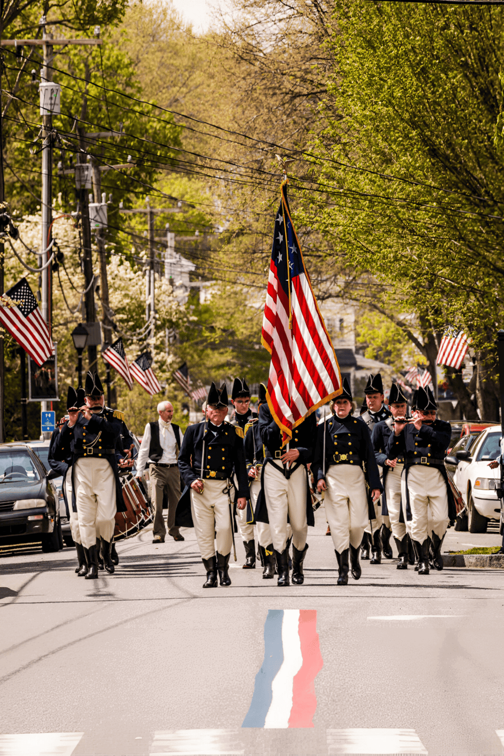 American flag parade at Memorial Day honoring military veterans and national pride on a spring day.
