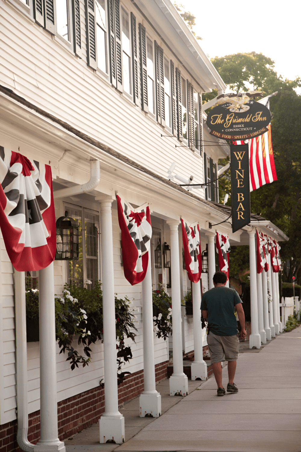 Cozy Inn exterior with festive patriotic decorations and wine bar signage in Connecticut.