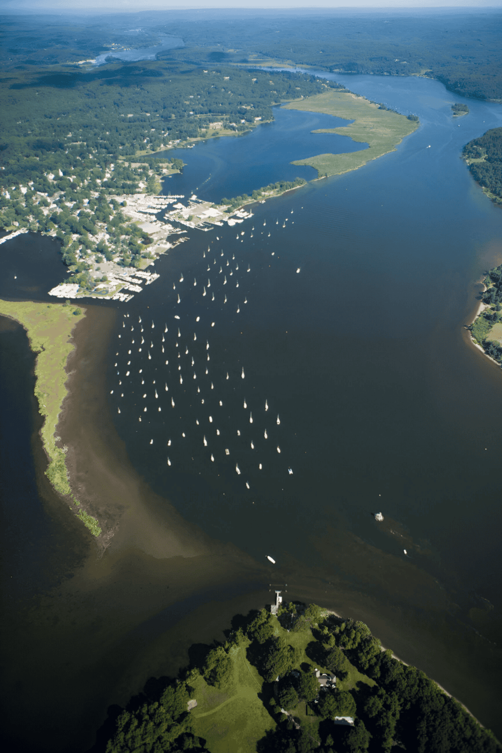 Serene waterway with boats and lush greenery, showcasing scenic vistas and boating opportunities.